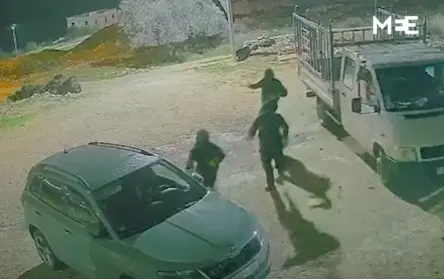 Settlers setting car on fire